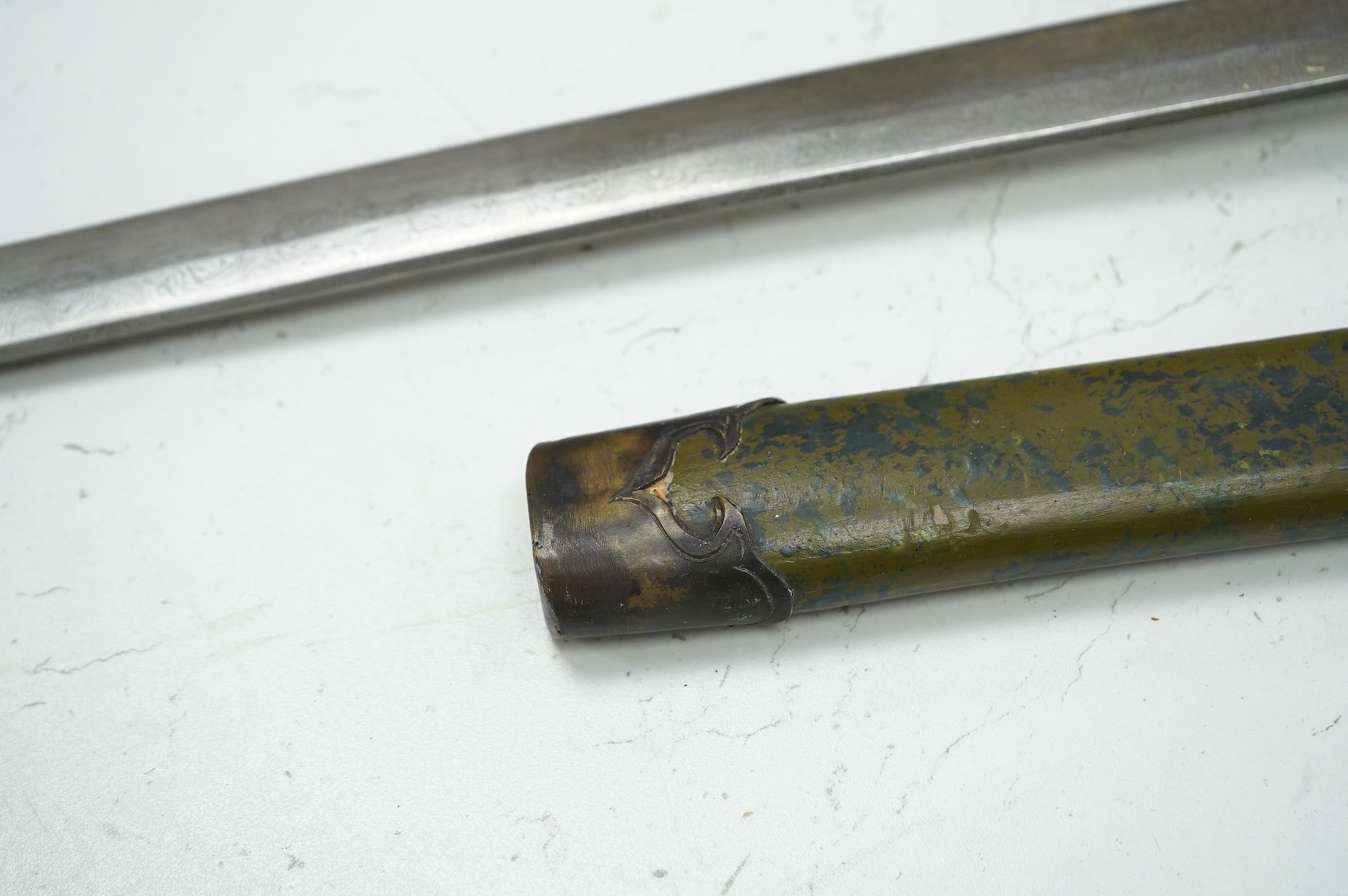 A well-made Chinese copy of a Japanese sword katana, blade etched with wood grain imitation, green painted handle, scabbard with engraved brass mounts